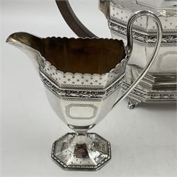 Victorian silver four piece tea service, comprising teapot, teapot stand, twin handled open sucrier and milk jug, each of octagonal form with foliate bud border and engraved decoration including crest to canted panels, and vacant panels, the teapot with ivory finial to the hinged cover and later wooden handle, hallmarked Edward Barnard & Sons Ltd, London1896, teapot including finial H15cm, milk jug including handle H16cm, teapot stand W11.5cm

This item has been registered for sale under Section 10 of the APHA Ivory Act