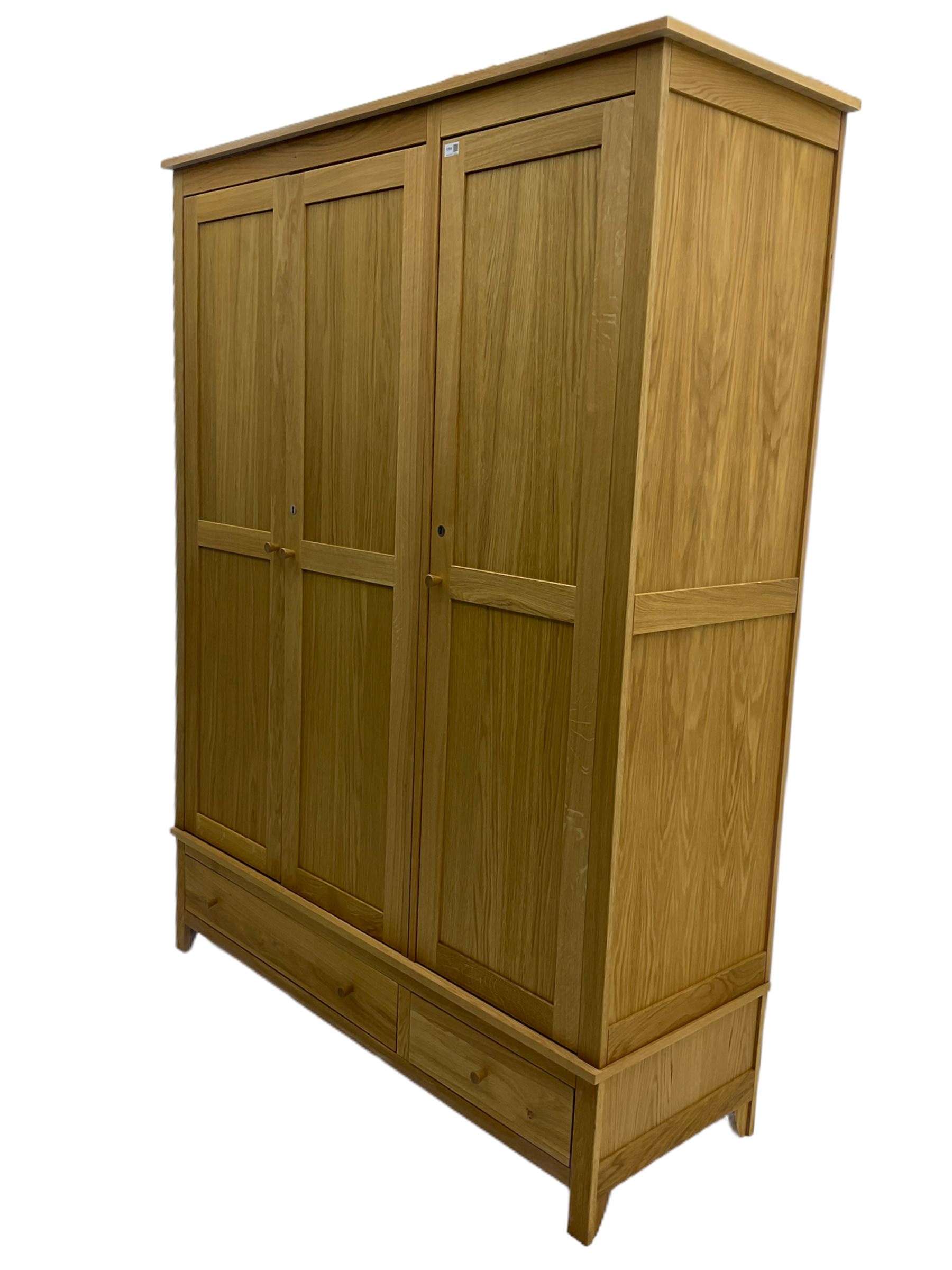 Corndell Furniture - light oak triple wardrobe, enclosed by three panelled doors, one long and one short drawer