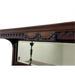 Late 19th century mahogany bookcase, the canopy top with moulded dentil cornice and fan carved spandrels on turned and reeded supports, rectangular bevelled mirror back, two astragal glazed doors with reed moulded slips enclosing fabric lined interior with two shelves, flanked by turned and reed carved columns with acanthus leaf capitals, on turned and carved feet