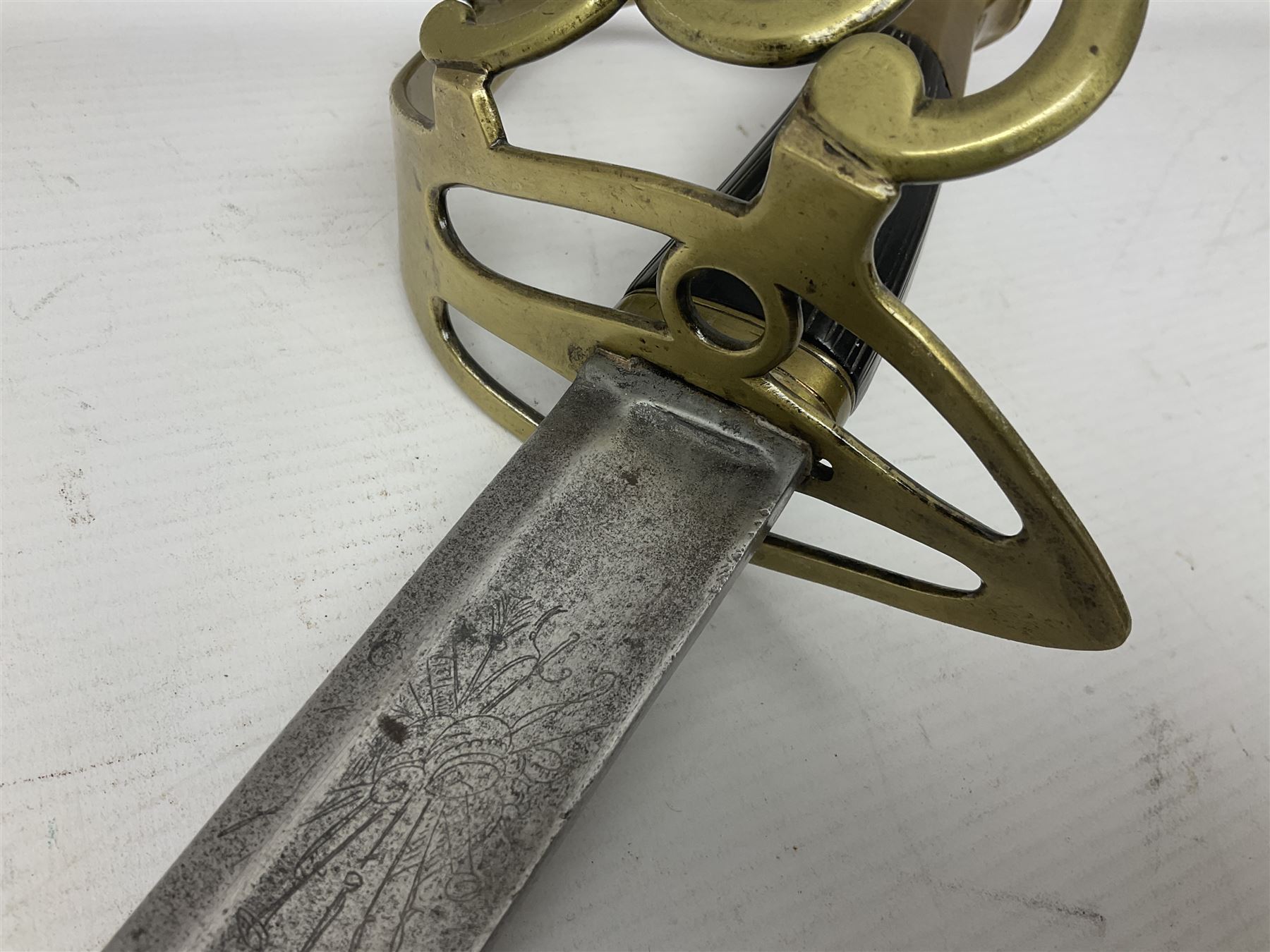 Late 18th century sword, the Spanish 79.5cm curving fullered blade engraved with the Royal Cypher, battle trophies and 'Viva Espania' banner, French Sabre de Mineur brass three-bar hilt with ebonised reeded grip L93.5cm overall (no scabbard)