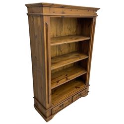Solid pine open bookcase, fitted with four open shelves and two drawers