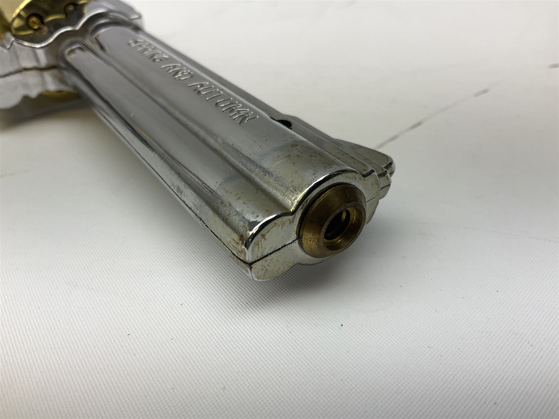 Early 20th century Flobert 5mm blank firing revolver with six-shot chamber, top venting, nickel plated with folding trigger No.118 L12.5cm overall; replica non-firing 'British Bulldog' revolver; and Windproof gas lighter inscribed 'Revolver-99 Spring and Autumn' in holster marked 'Star-Line'