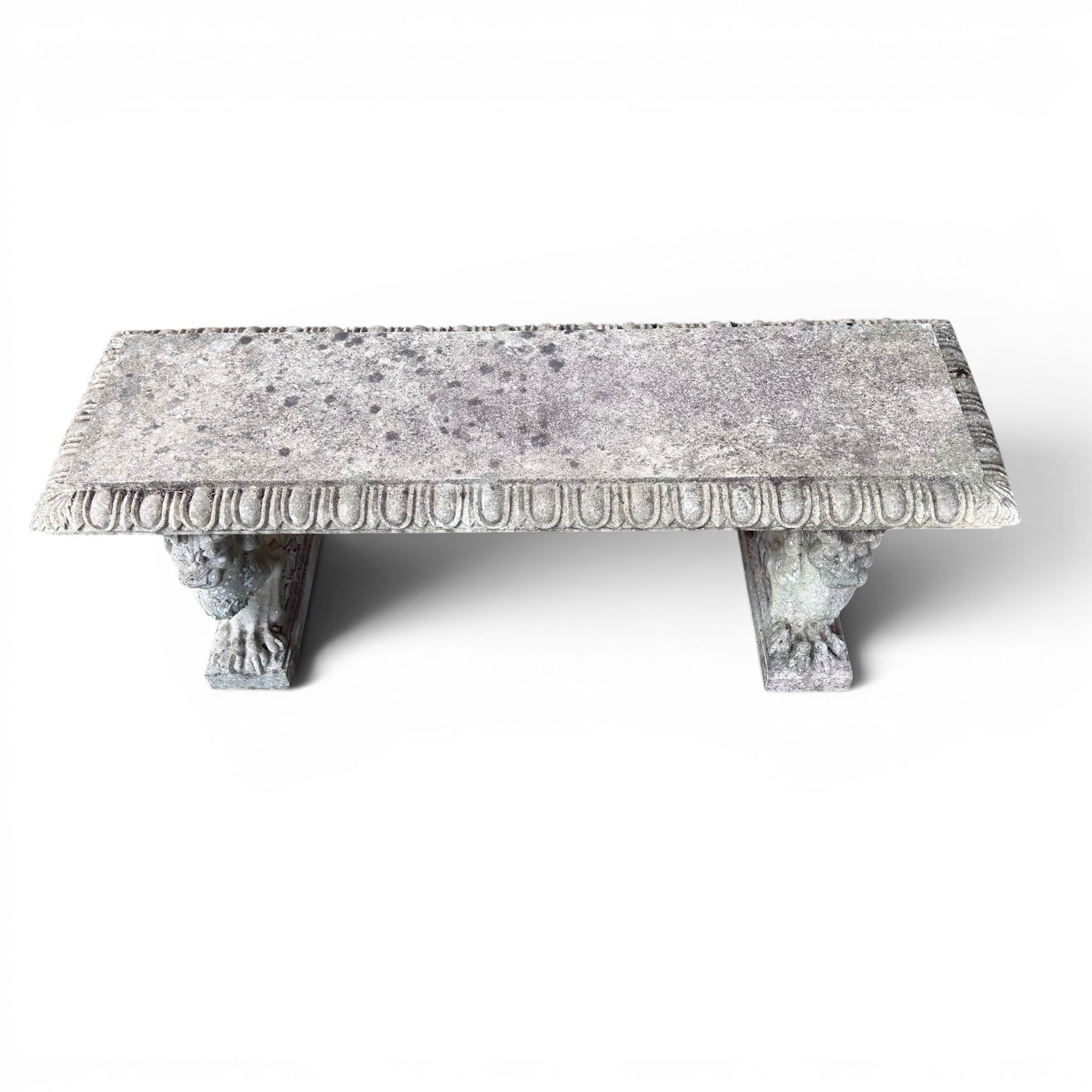 Ornate weathered cast stone rectangular garden bench, raised on winged griffin supports, square plinth bases