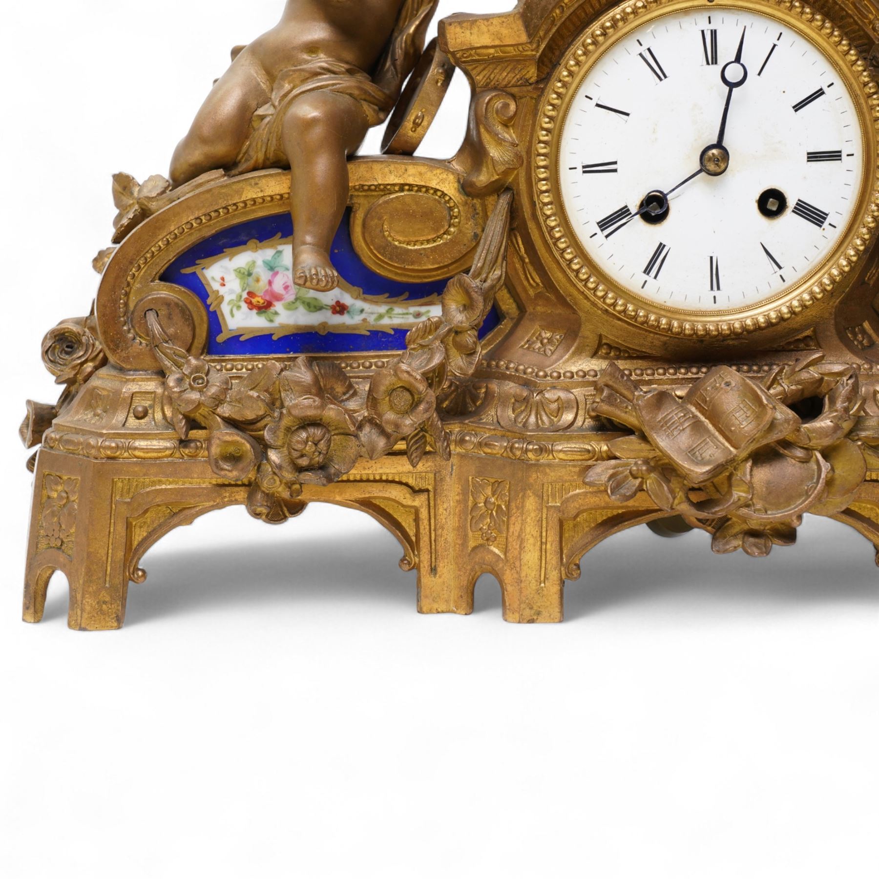 French-late 19th century gilt and spelter mantle clock, highly decorative case with two Sevres style porcelain panels to the front and surmounted with three figures of children playing musical instruments, white enamel dial with Roman numerals and steel moon hands, two train countwheel strike movement, striking the hours and half hours on a bell. With key and pendulum.    