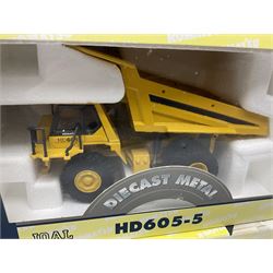 Four Joal Komatsu 1:50 scale die-cast models comprising WA600-3 Log Loader, HD605-5 Dump Truck and two PC1100LC-6 Material Handler, together with a CAT Articulate Truck, all boxed (5)