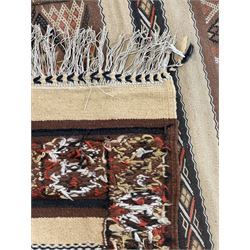 Turkish Kilim ground rug, the field with alternating horizontal bands of geometric patterns, bordered by repeating diamond motifs (145cm x 242cm); Turkish red ground rug, the field with three octagonal medallions (113cm x 172cm) (2)