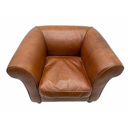 Armchair upholstered in tan leather, walnut feet with brass casters