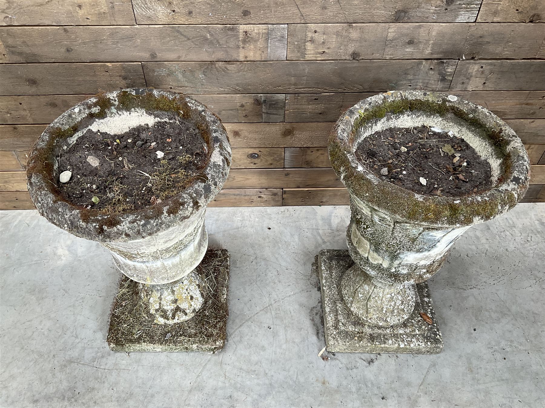 Pair of Regency design weathered cast stone garden urns