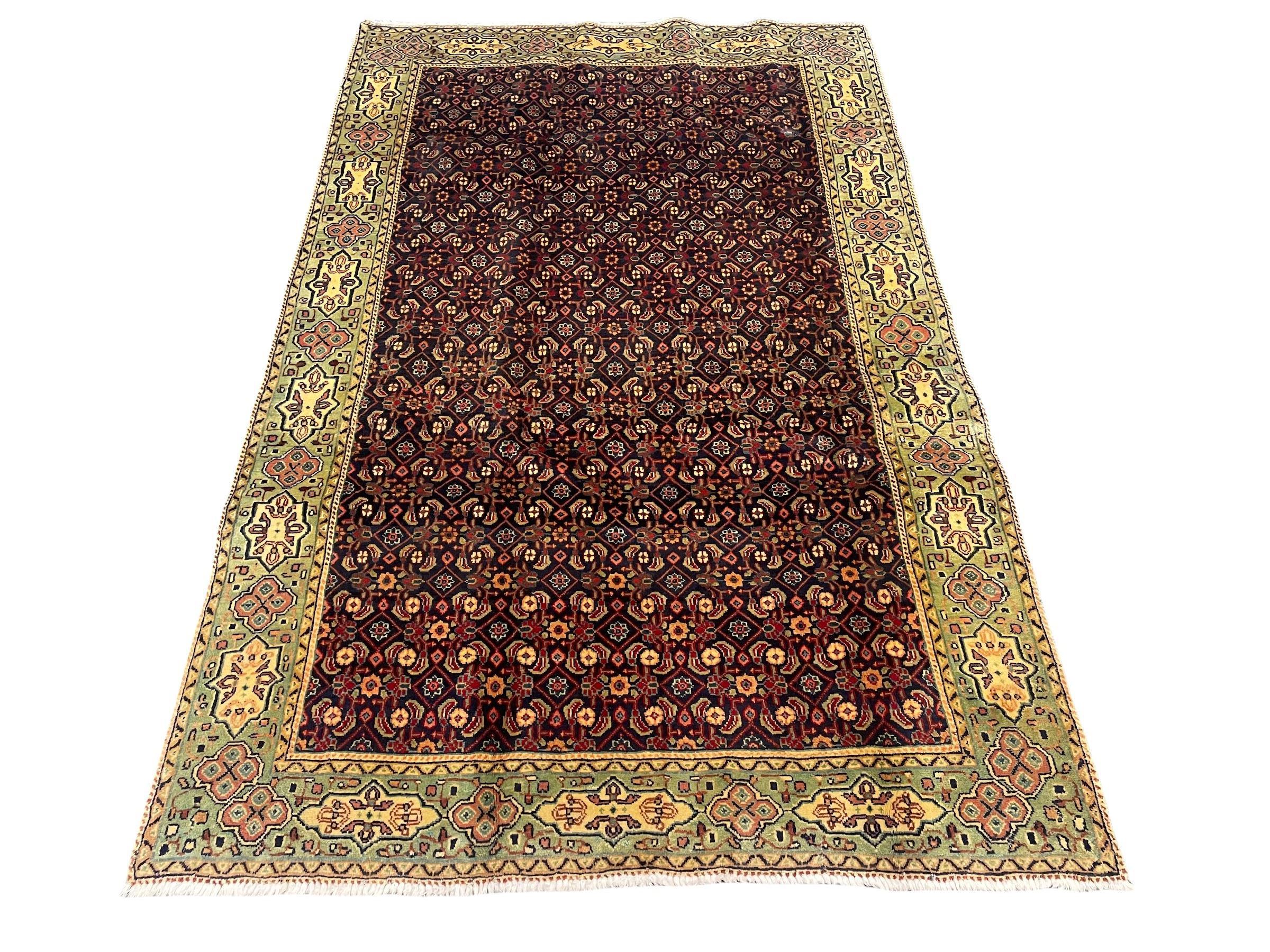 Persian Mahal rug, the blue ground field decorated with repeating Herati motifs, guarded pale ground border decorated with stylised panels