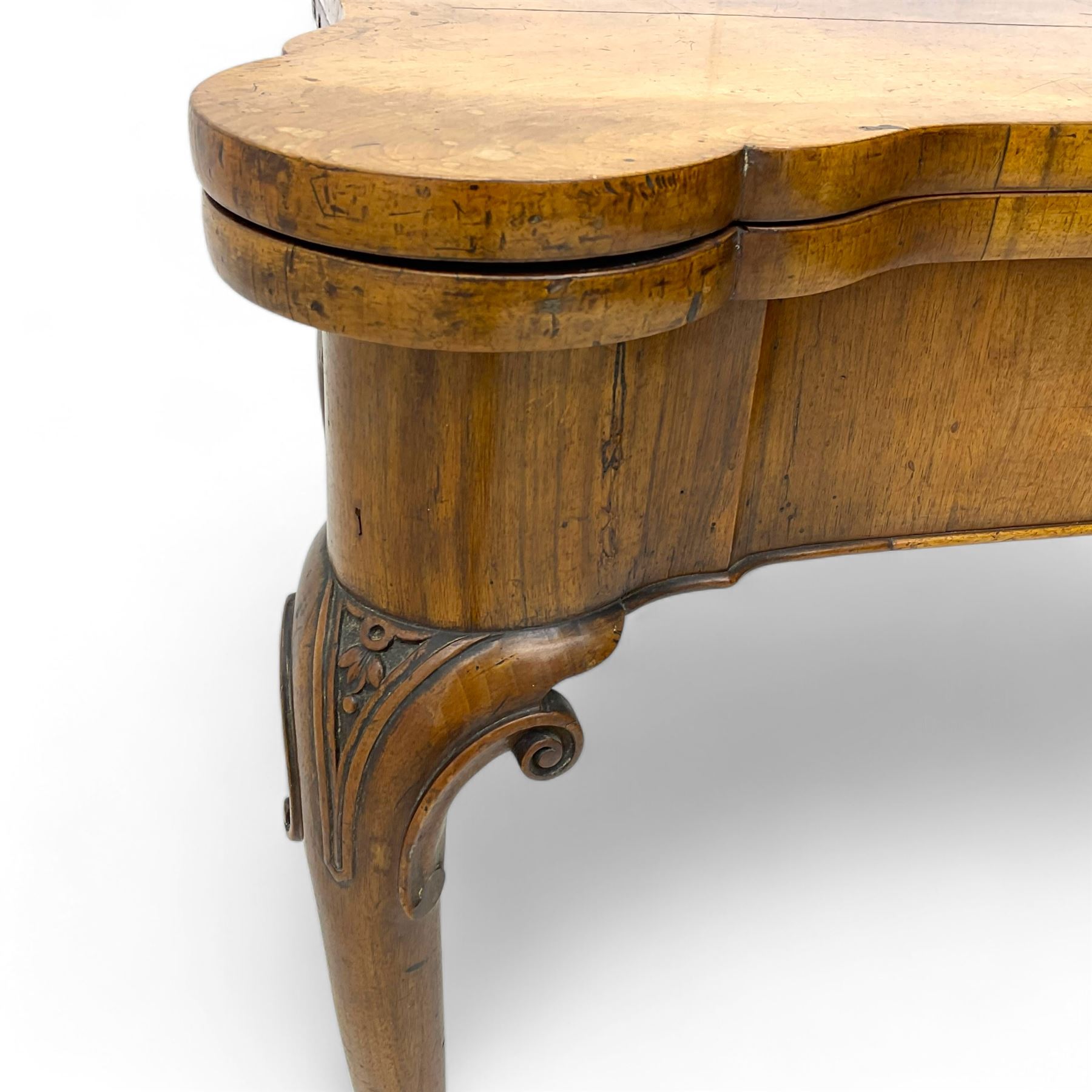 Georgian walnut fold-over card table, shaped rectangular top opening to reveal a baize-lined surface, supported by a concertina pull-out rear mechanism, frieze fitted with single drawer, raised on cabriole supports with foliate carvings terminating in pad feet