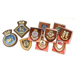 Various Navy wooden heraldic shields each with hand painted raised shield, including HMS Indefatigable, HMS Nelson,  HMS Victory etc, ten in total.  