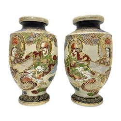 Pair of early 20th century Japanese Satsuma vases, decorated with immortals, with painted mark to base, H26cm
