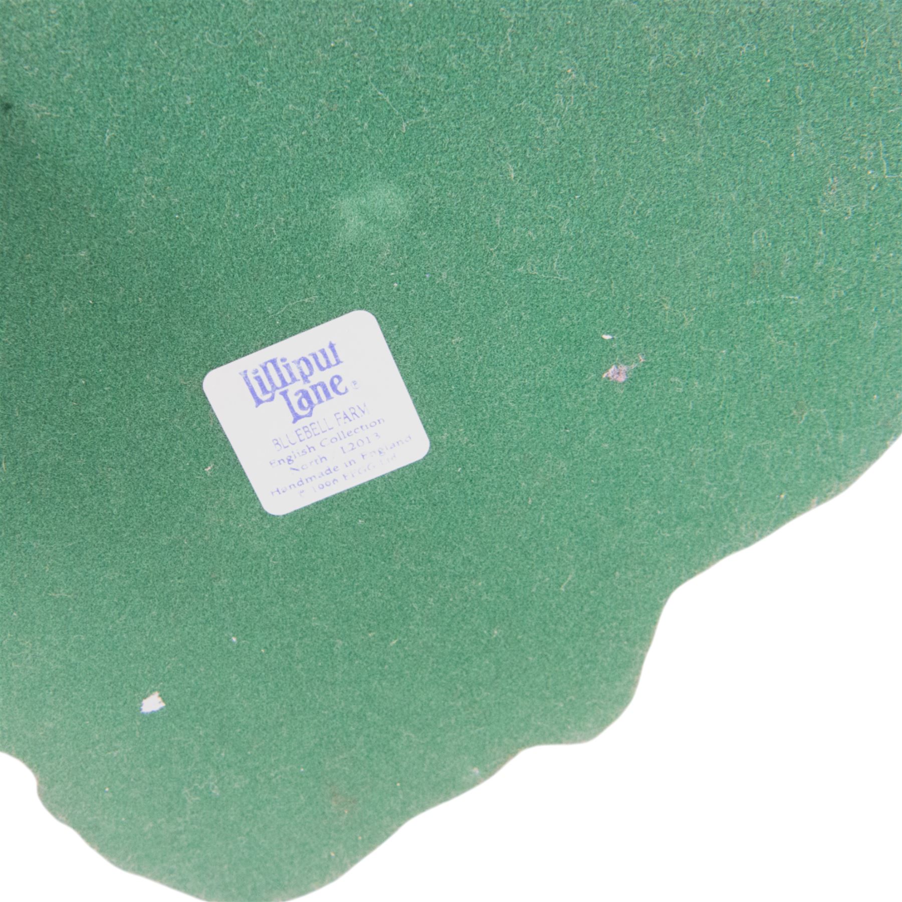 Four Lilliput Lane models, comprising Oakwood Smithy, We Plough the Fields and Scatter, Bluebell Farm and Highghyll Farm