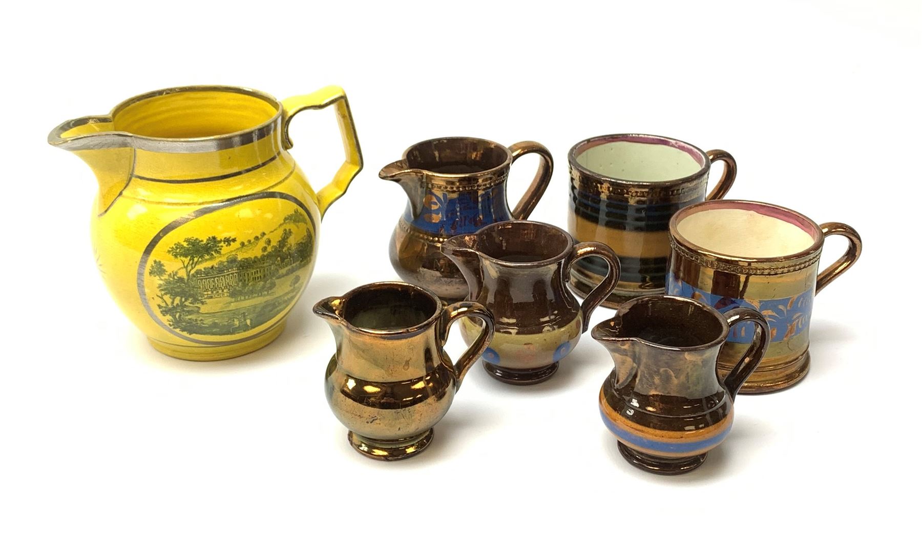 An early 19th century Staffordshire yellow ground jug, printed with two oval scenes of a country