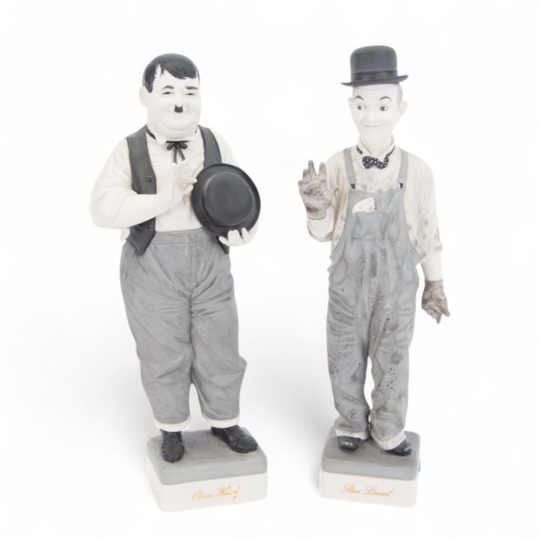 Pair of Spanish Algora Personajes Del Cine figures, modelled as Stan Laurel and Oliver Hardy, with printed marks beneath, both with certificates of authenticity, H37cm