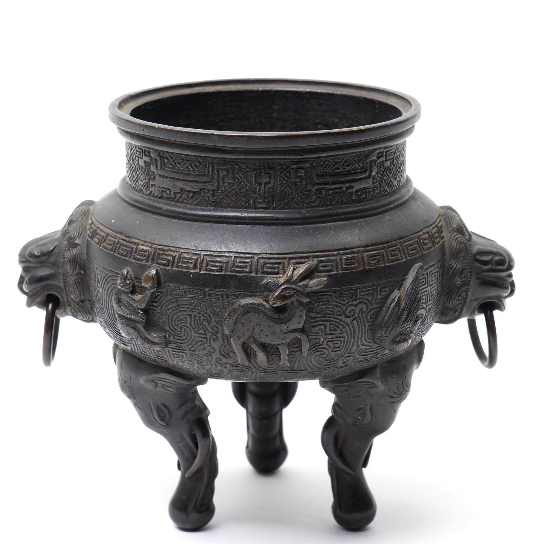 Early 19th century Chinese Qing Dynasty bronze censer, the body of globular form with circular neck and twin cast lion mask ring handles, decorated with applied figures of a monkey, deer and bird, against a key fret detailed ground, the whole upon three zoomorphic elephant feet, H16.4cm D12cm