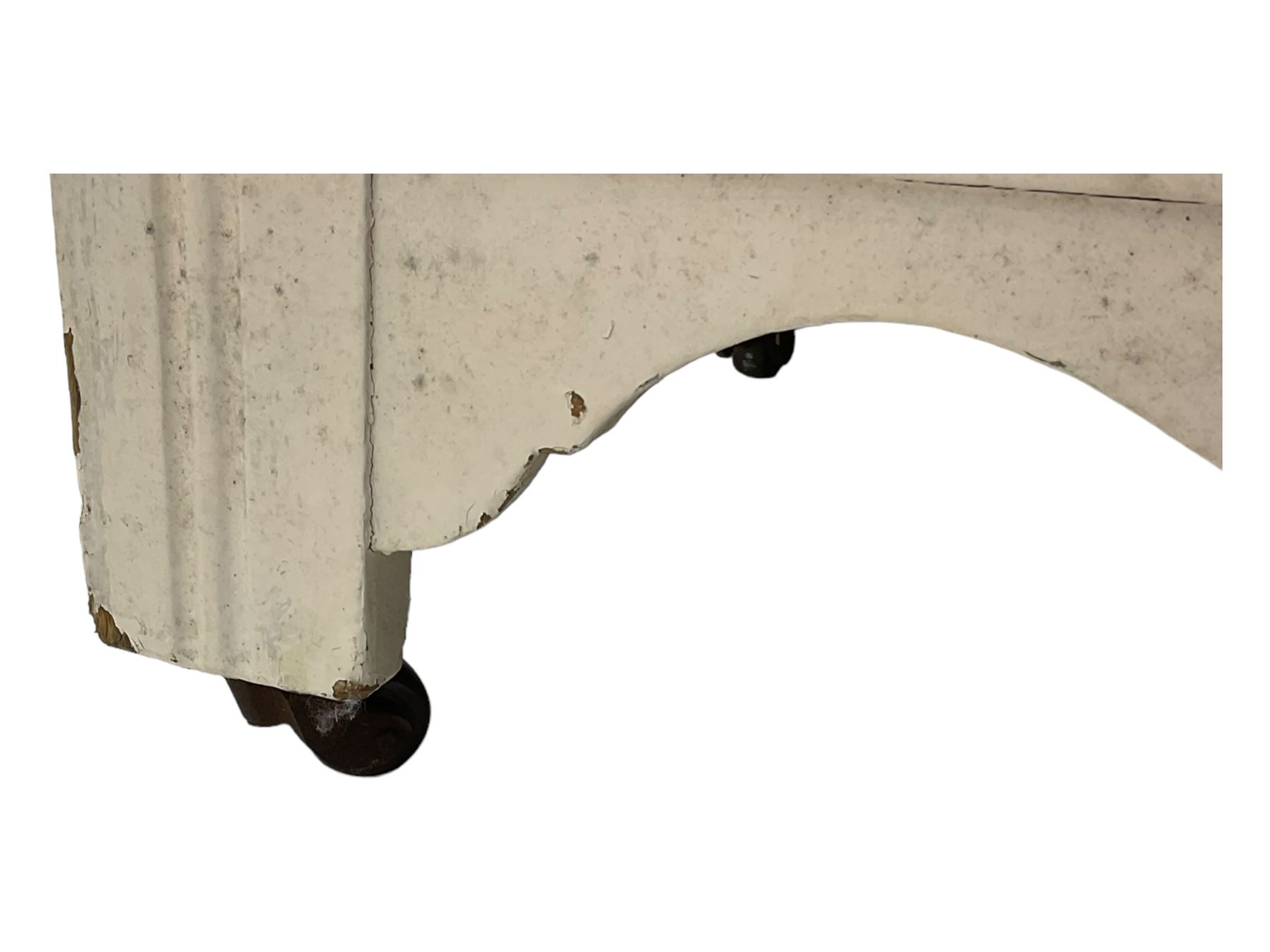 20th century painted pine chest of drawers, rectangular top over two short and two long drawers, scalloped apron, on castors