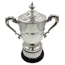  Silver twin handled lidded trophy cup by William Hutton & Sons Ltd, Sheffield 1921, inscribed on plinth 'Scottish Grand National Bogside 10th April 1965 won by Mr E.D.Gosschalk's 