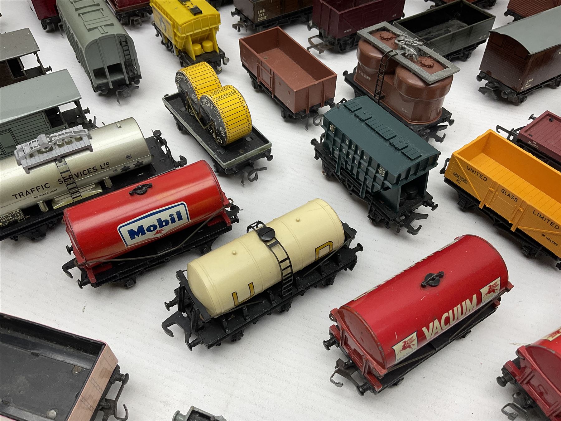 Hornby Dublo - forty-three goods wagons including nine tank wagons (Esso, Mobil, Vacuum, UD and Traffic Services), brake vans, meat and fish wagons, bogie well and bolsters, cable drums, open wagons, salt and grain wagons, etc; and six others by Tri-ang etc; all unboxed (49)