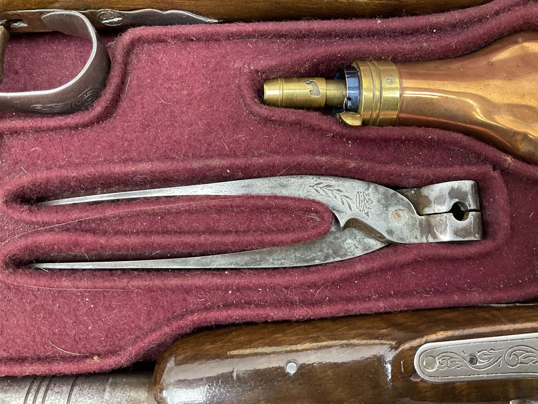 SECTION 1 FIREARMS CERTIFICATE REQUIRED OR REGISTERED FIREARMS DEALER - Pair of Reproduction Continental .44 calibre percussion target pistols, each with heavy 23.5cm octagonal to round barrel bearing various marks, crude scroll engraving to lock plate, hammer and octagonal section of barrel, unchequered walnut stock with brass butt plate and steel hooked trigger guard, numbered 8138 & 8164, L41.5cm overall; in maroon baize lined converted sapele mahogany fitted case bearing reproduction trade label for Trulock & Son Dublin containing small copper powder flask, steel scissor action bullet mould, nipple key, turned wooden mallet and lidded box, steel rammer and wooden cleaning rod, case L48cm
