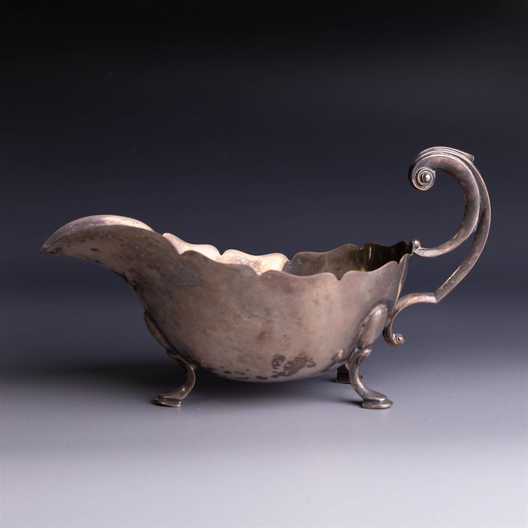 1930s silver sauceboat, of typical form with shaped rim and flying C scroll handle, upon three stepped feet, hallmarked Collingwood & Sons Ltd, Sheffield 1938