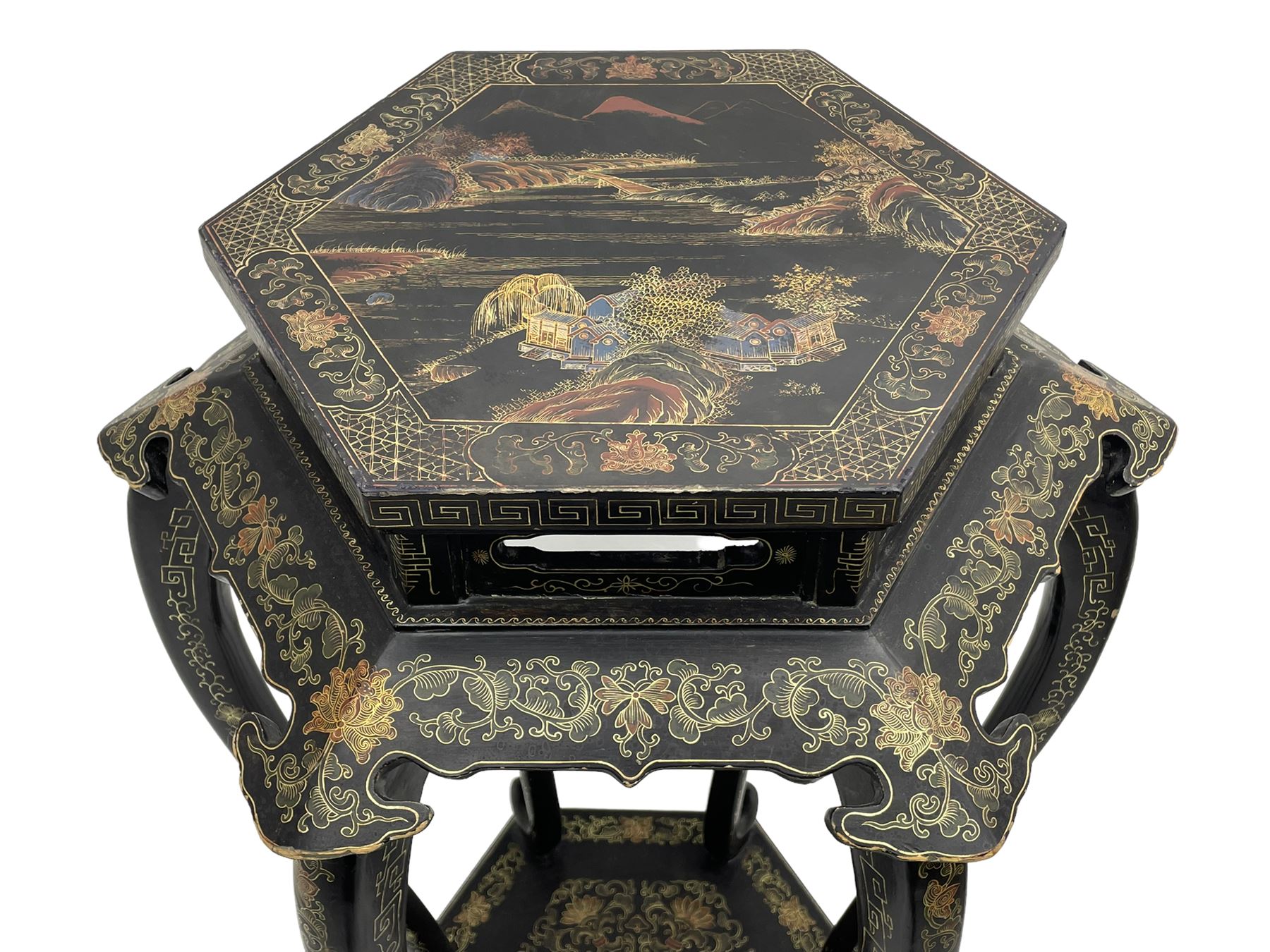 Chinese black lacquer jardinière stand, the hexagonal top painted with traditional landscape scenes within a gilt strung border, the pierced frieze with trailing foliate decoration and geometric patterns, supported on six cabriole supports united by a raised hexagonal base