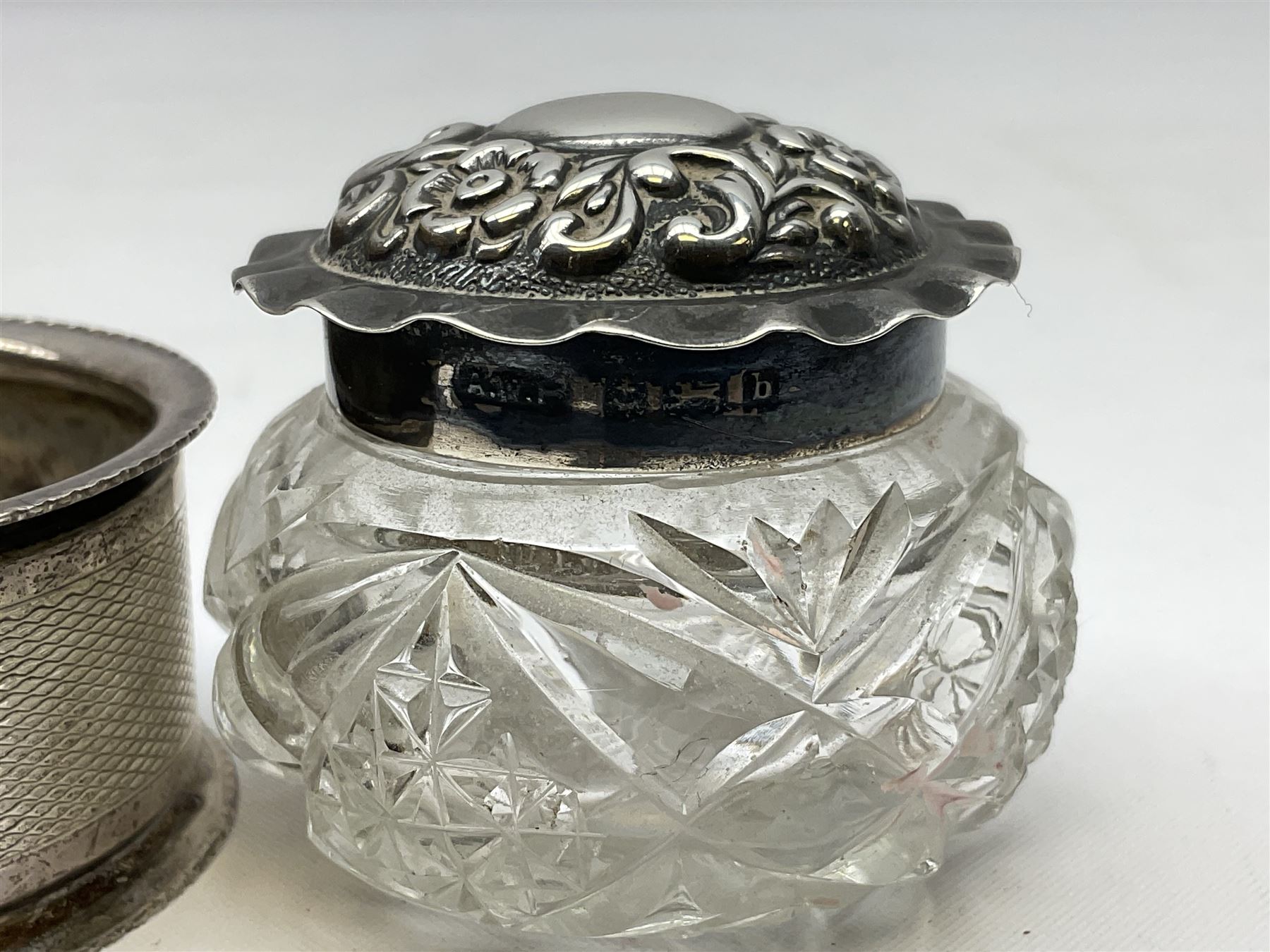 Two silver napkin rings, silver spoon with thistle top terminal, two silver handled butter knives, and small glass jar with silver cover, all hallmarked, approximate weighable silver 53.7 grams