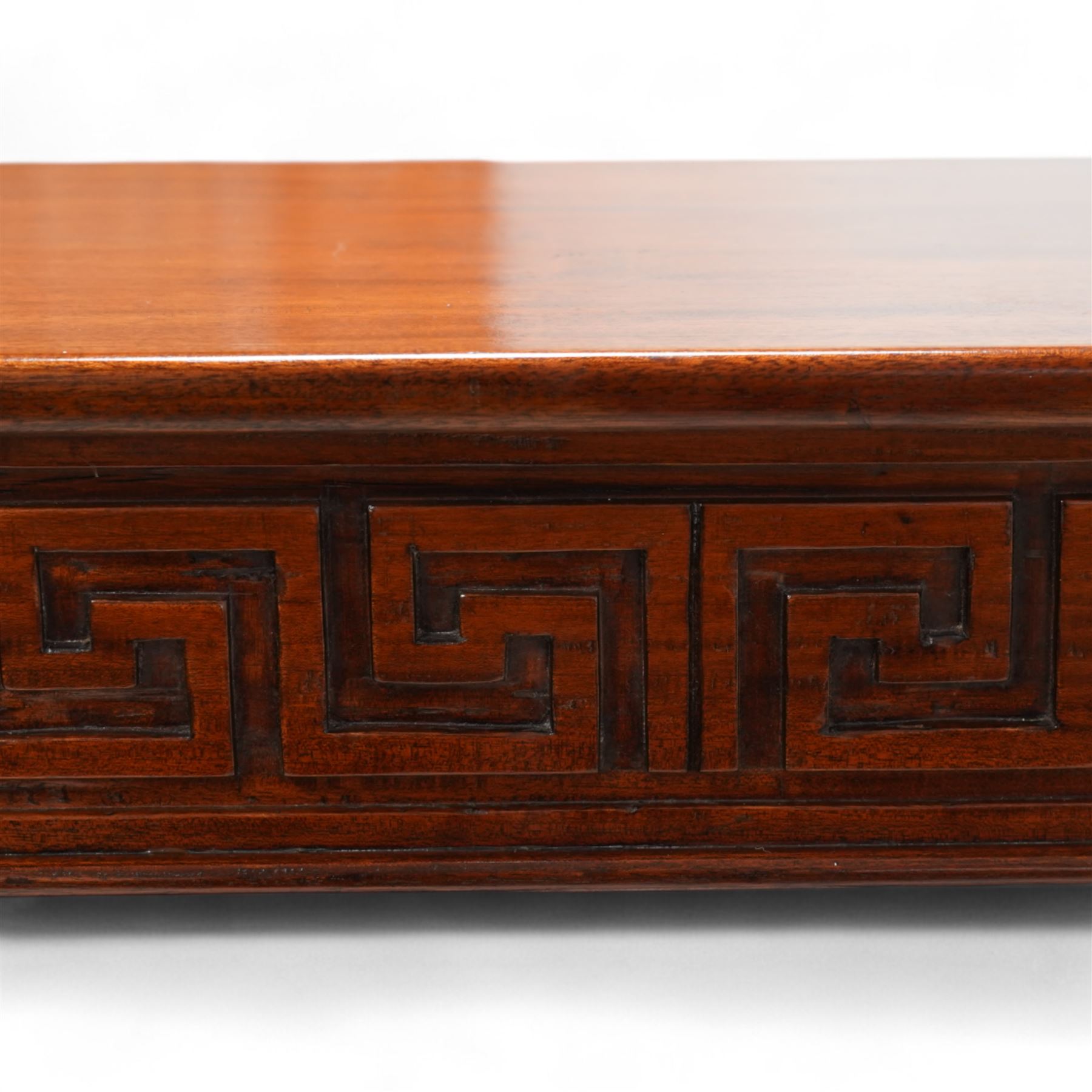 Neoclassical design mahogany console table, rectangular top over Greek key carved frieze with foliate carved back and sides, raised on twin pilaster end supports with acanthus capitals, on a plinth base