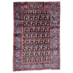 Persian blue ground rug, the navy field decorated with repeating Boteh motifs with interconnecting flower heads, guarded teal border with stylised floral patterns