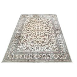 Persian design ivory ground rug, decorated all-over with interlacing foliate, plant and flower head motifs, repeating and scrolling border with guards