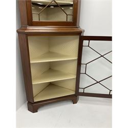 Early/mid century mahogany corner display cabinet, projecting cornice above two astragal glazed doors, enclosing lined interior with five shelves, shaped bracket supports 