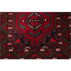 Four small Persian and Caucasian design rugs, comprising a Kazak rug with twin hooked medallions on a red ground, Baluchi rug with geometric motifs on a muted red ground, Shiraz rug with a central ivory and red medallion on a blue ground, and a Bokhara mat with four guls on a rose ground, each enclosed by geometric borders, largest 143cm x 88cm (4)