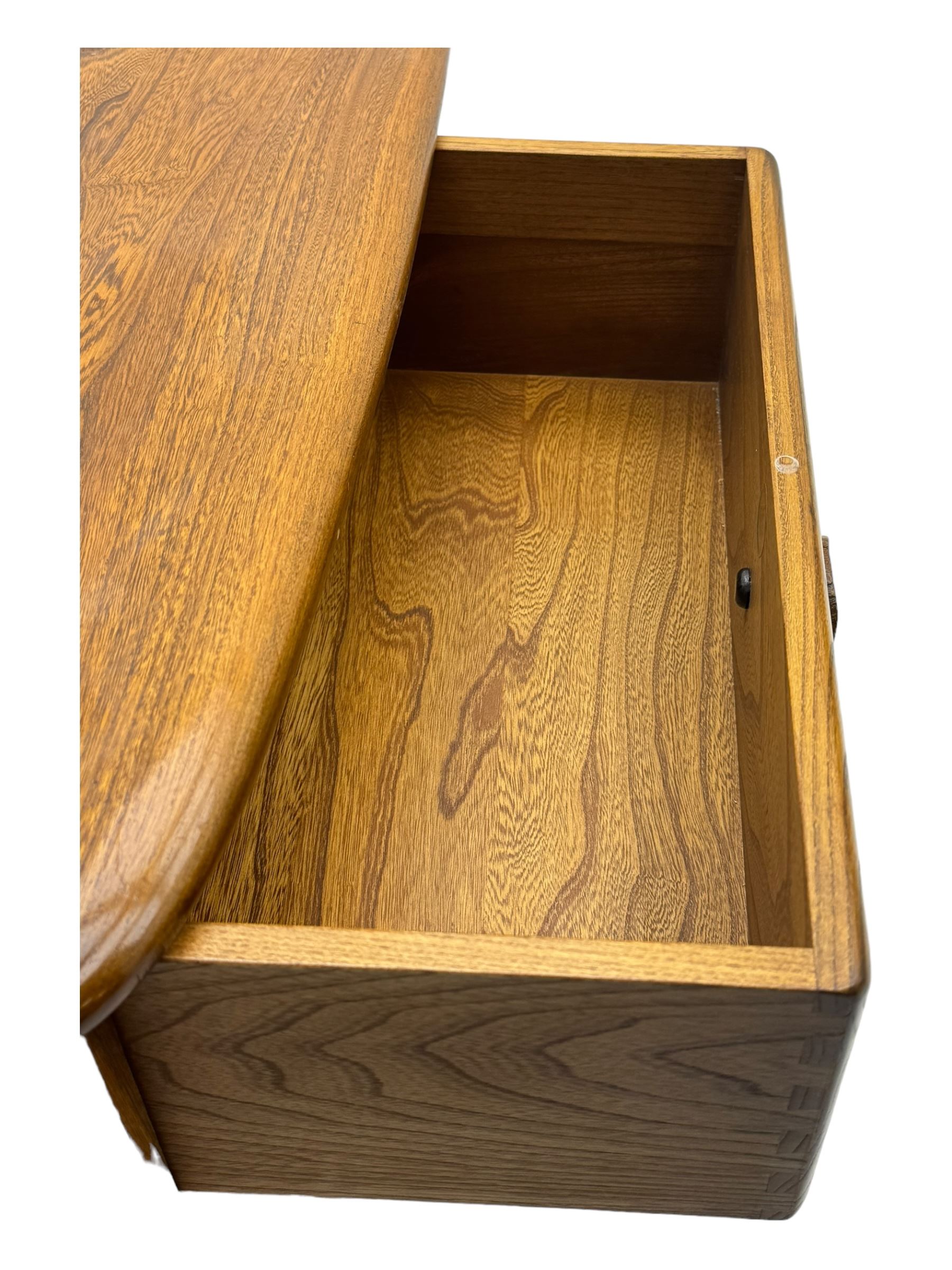 Lucian Ercolani for Ercol - elm 'Pandora's Box' coffee table, square top with rounded corners over two drawers with sculpted recessed pulls, open sides supporting undertier, on castors 