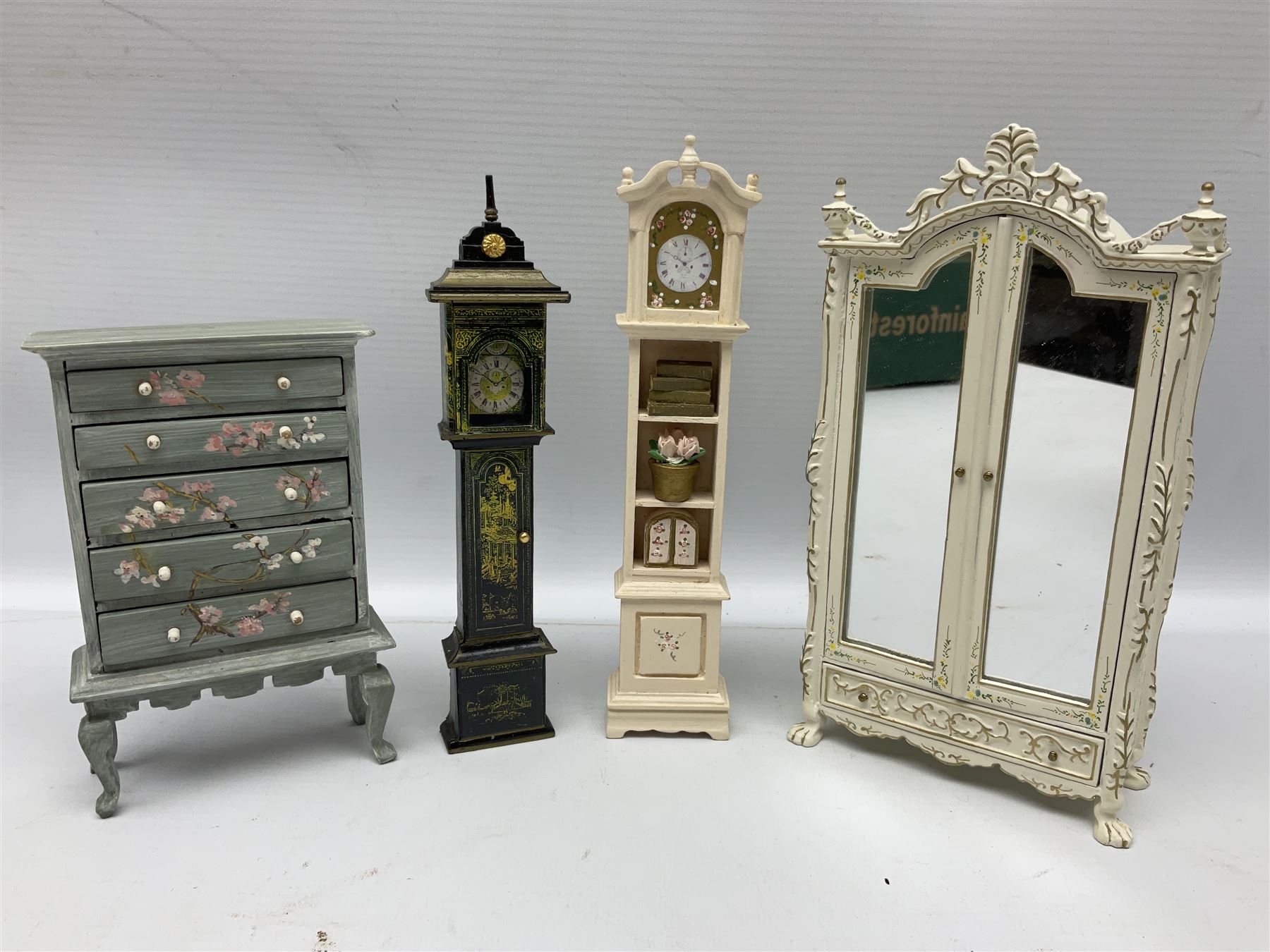 Collection of miniature dolls house furniture, to include five drawer chest painted with blossom, cream and gilt double door mirrored wardrobe, four piece lacquered style desk set, three piece suite, writing desk, wash stand, Knoll style sofa etc (14)