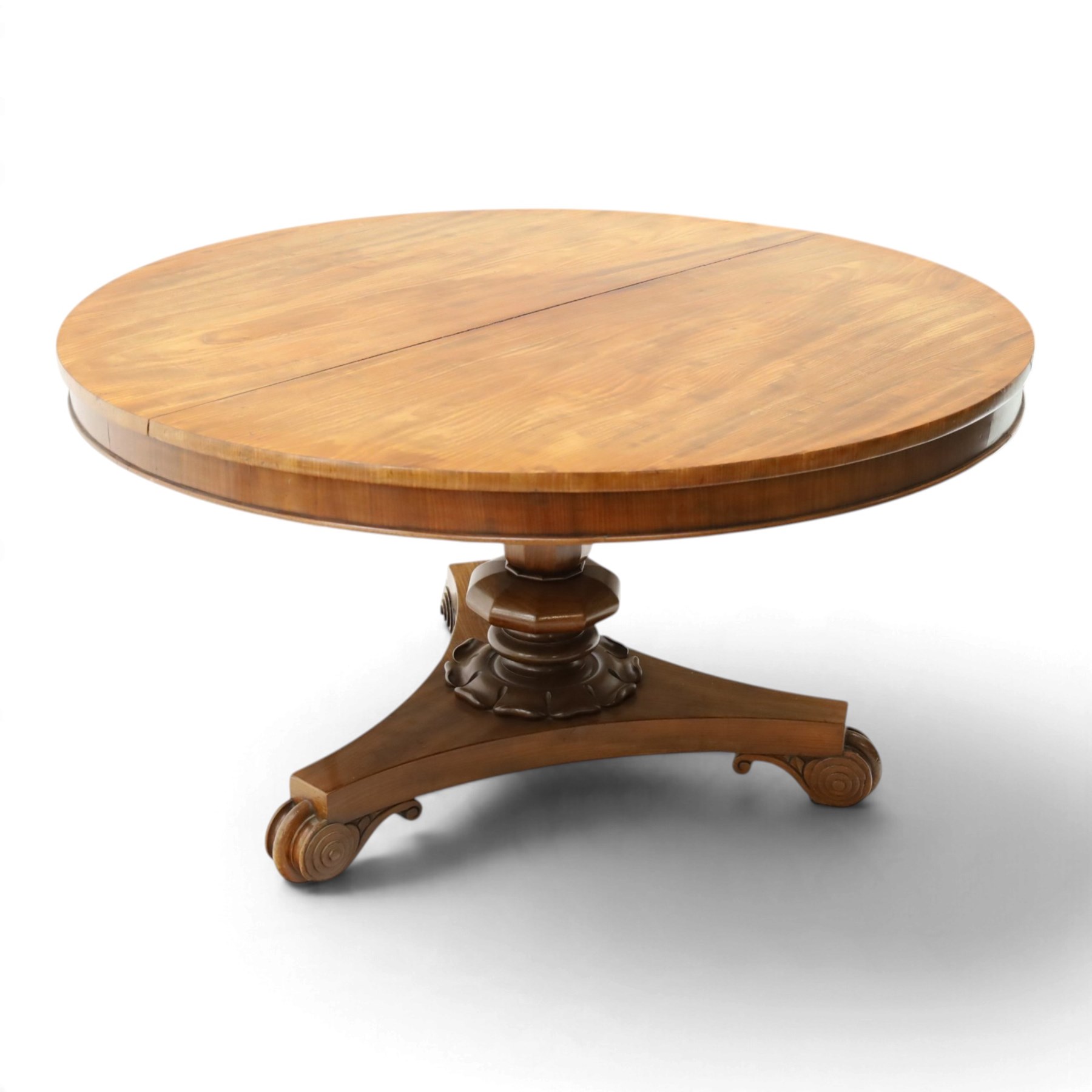 William IV mahogany circular breakfast table, banded frieze over a turned decagon pedestal with lappet carved collar, terminating to a triform platform base with scroll feet and castors