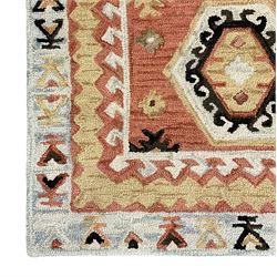 OKA - Turkish design peach ground rug, the field decorated ejder motifs within hooked and geometric design borders 