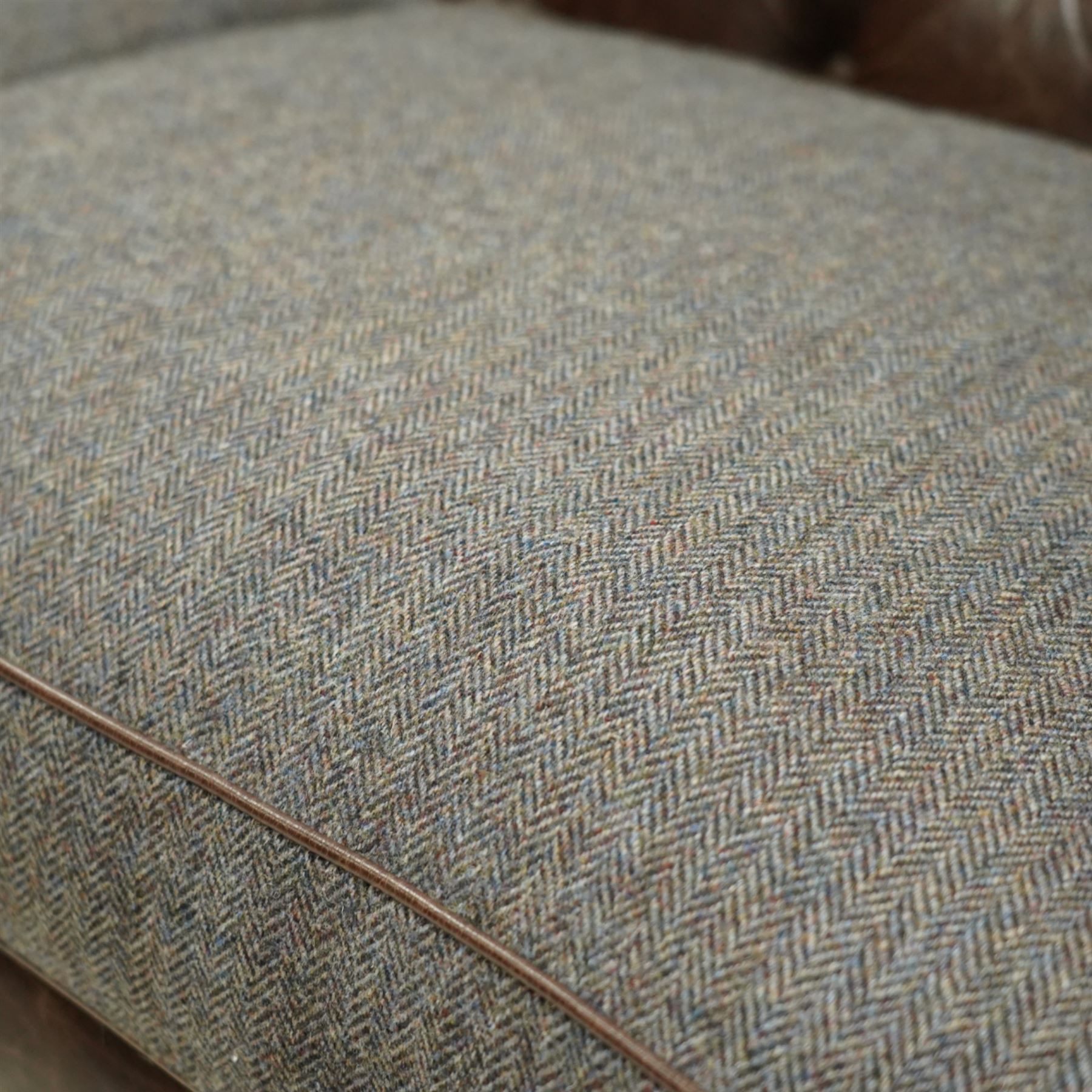 Tetrad - Harris Tweed and leather upholstered Chesterfield sofa, curved back and arms  with deep buttoned brown leather upholstery above loose herringbone tweed seat cushions with brown leather piping, raised on turned wooden feet 