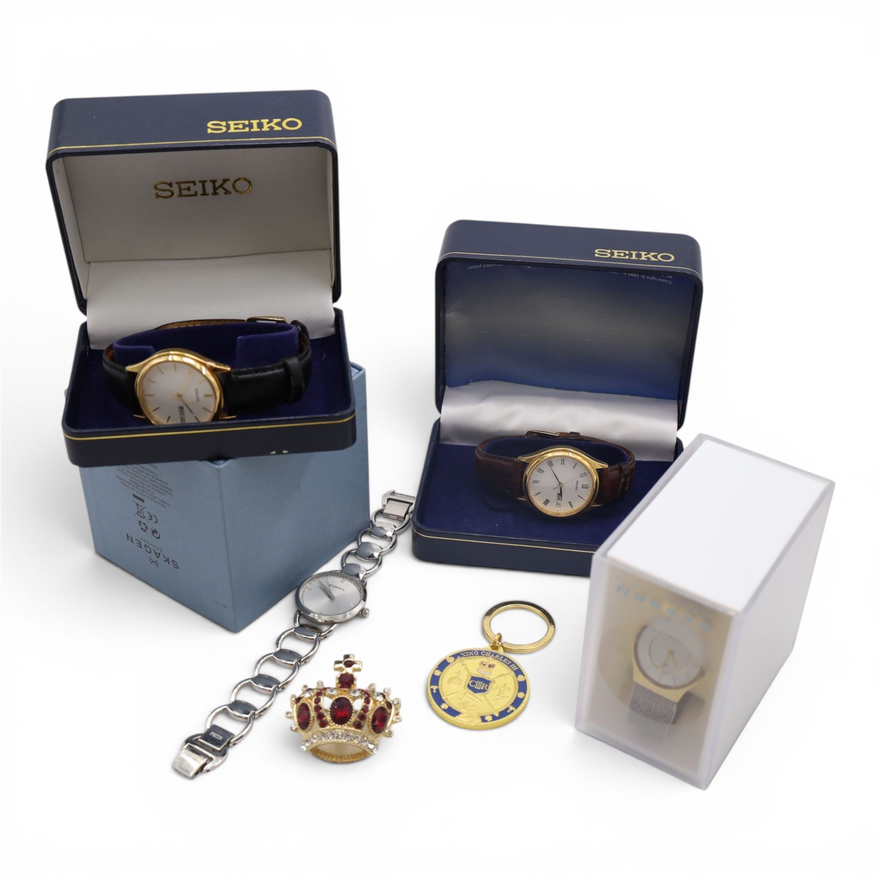Two Seiko wristwatches, two Skagen wristwatches, brooch and keyring