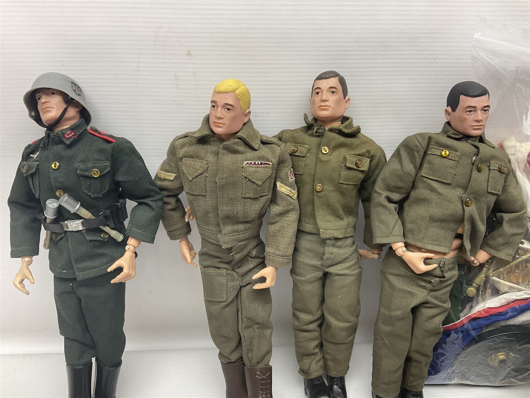 Action Man - five figures marked on the back 'Made in England by Palitoy under licence from Hasbro 1964', one dressed as a German Stormtrooper, one as a Red Devil Pilot and three in army uniform; another similar action figure marked to the right buttock ' G.I. Joe Copyright 1964 by Hasbro Patent Pending Made in Canada' dressed in army uniform; together with an Action Man jeep, field gun, mortar and machine guns and other accessories including helmets and weapons, parachute, diving equipment, skis and snow shoes, boots, uniforms etc; all unboxed
