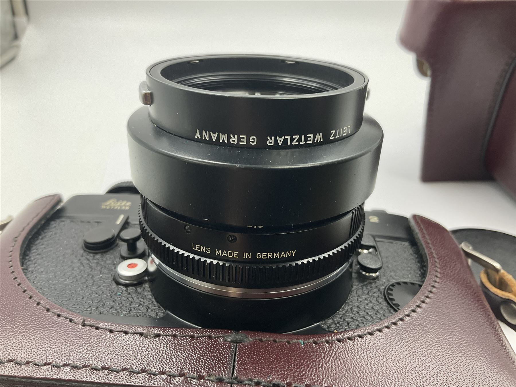 Leitz Leicaflex SL2 camera body, serial no.1387046, with 'Summicron-R 1:2/50 Leitz Wetzlar' lens, serial no. 2273397, within a leather Leitz lens hood 