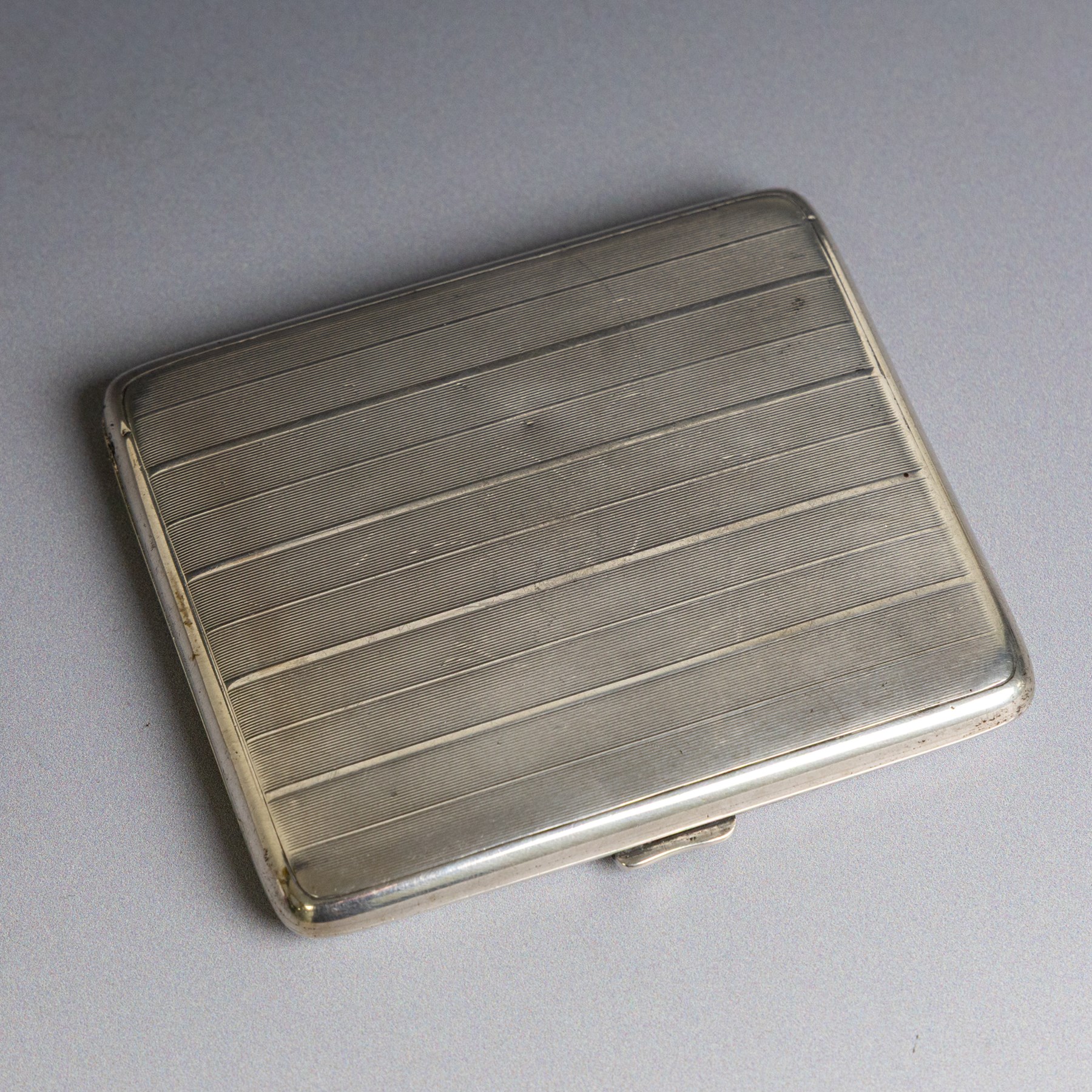 1920s silver cigarette case, of rectangular form with engine turned decoration, hallmarked Alfred Dunhill & Sons, London 1929, H9.5cm