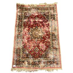 Antique Persian red ground rug, decorated with central pole medallion, guarded border with repeating palmettes