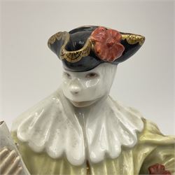 18th century Meissen figure of a Avvocato or the Lawyer from the Commedia Dell'arte series, circa 1740-45, modelled by J J Kandler, wearing gilt edged black tricorn hat, white mask, and yellow cape adorned with red rosettes, holding a scroll in his right hand, upon shaped oval base, no visible mark, H14.5cm