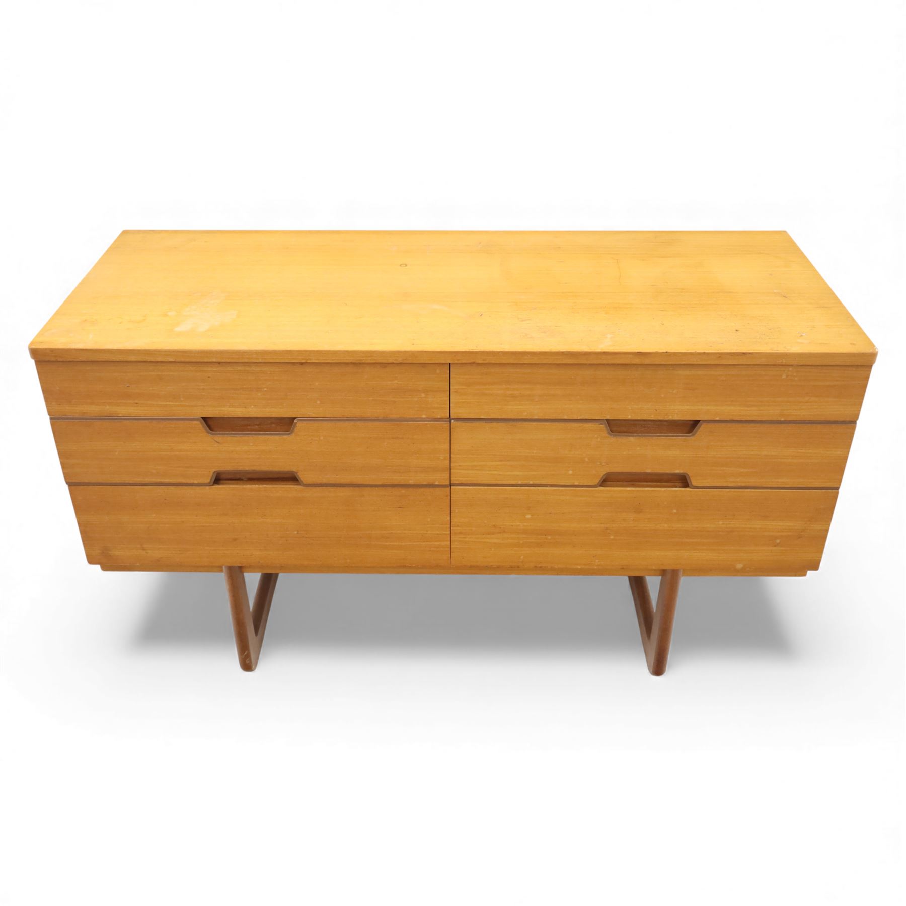 Uniflex - Mid 20th century teak sideboard, rectangular top over six drawers with recessed finger pulls, raised on U-shaped teak supports
