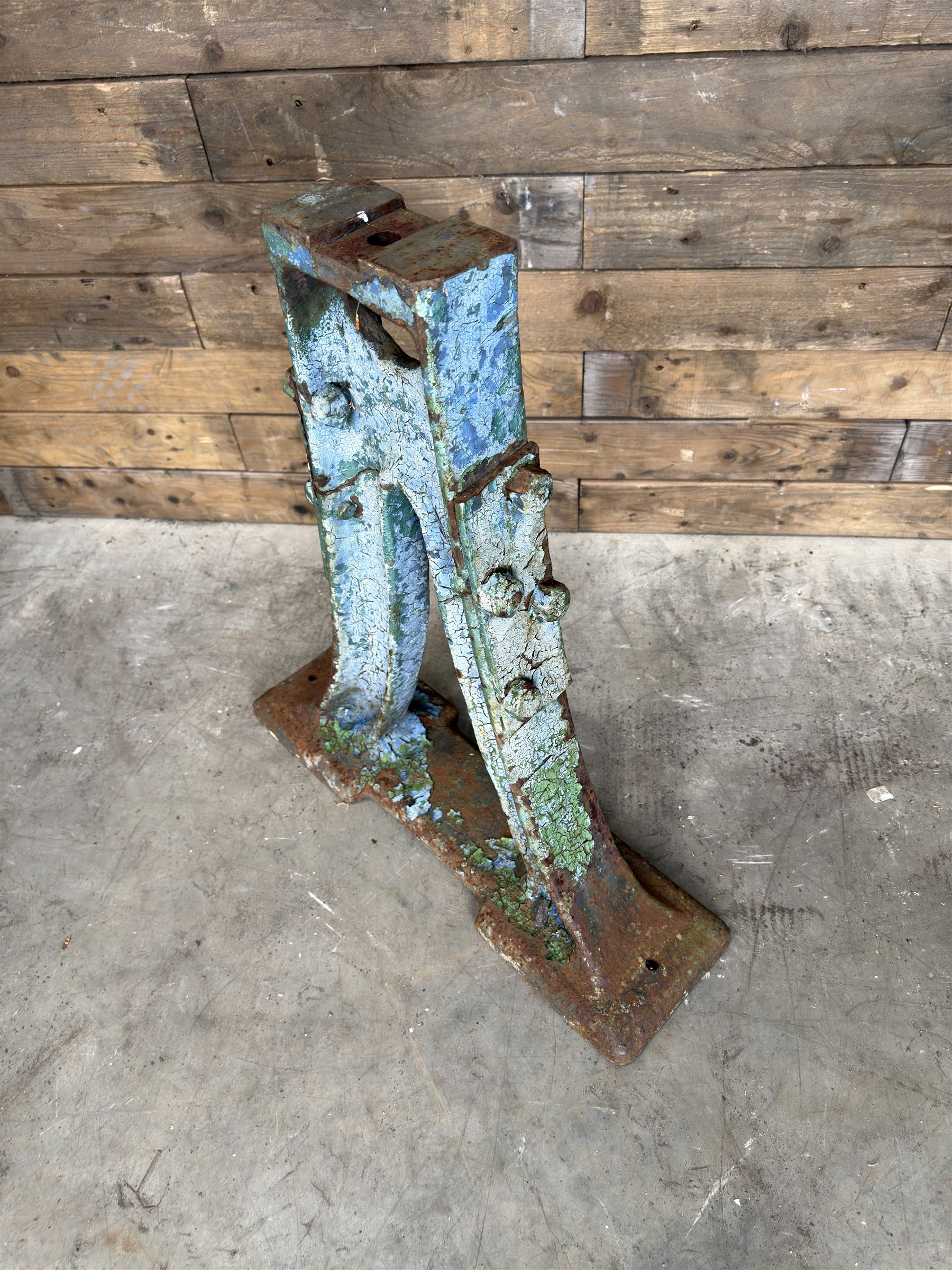 Pair of late 19th century heavy cast iron garden industrial trestles, painted in distressed blue paint