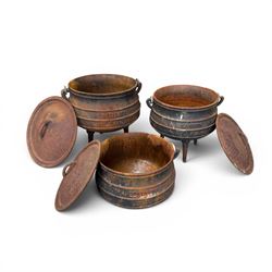 Three South African cast iron graduating cooking pots with lids and handles. Size shown for the largest