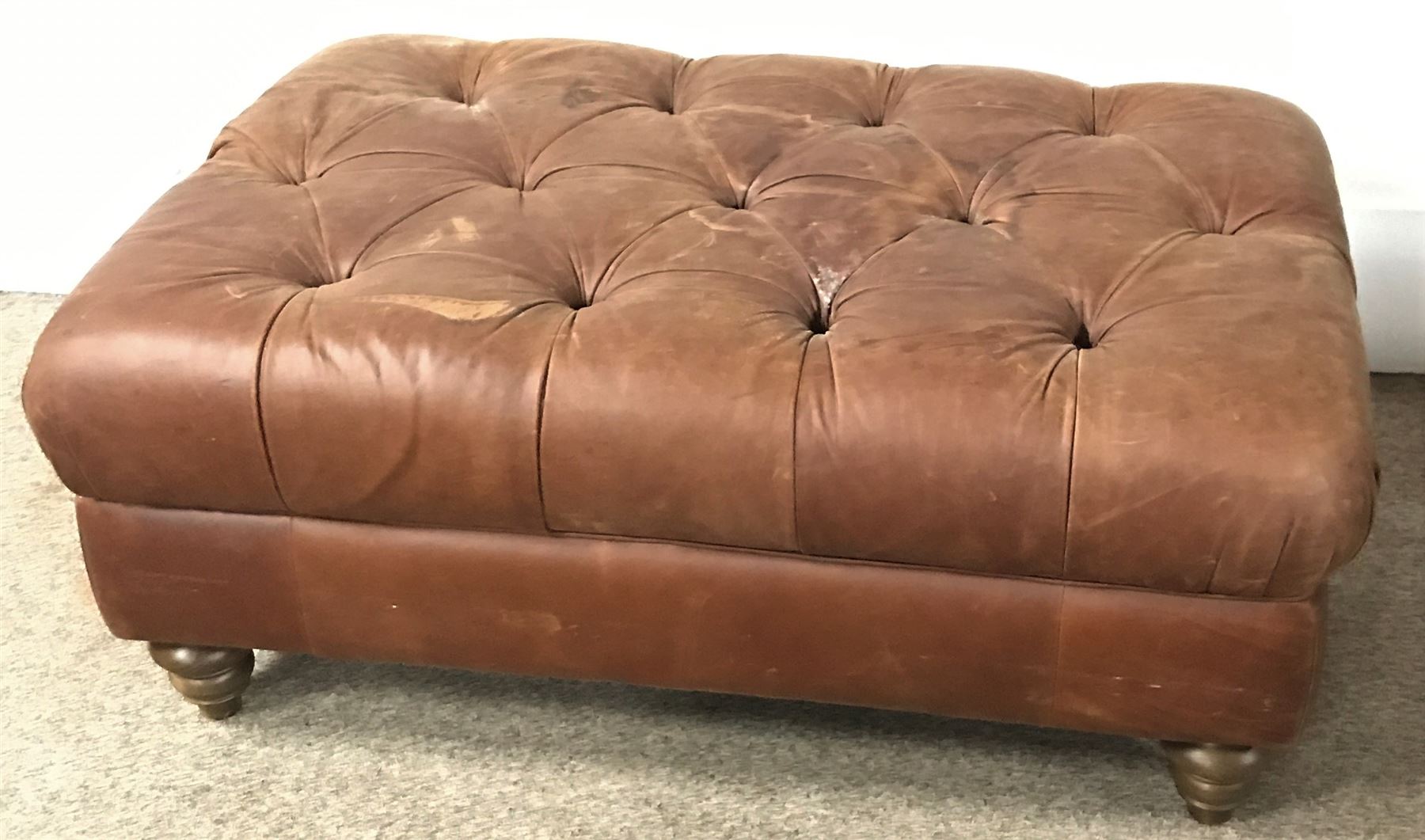 Large rectangular footstool upholstered in a deep buttoned fabric