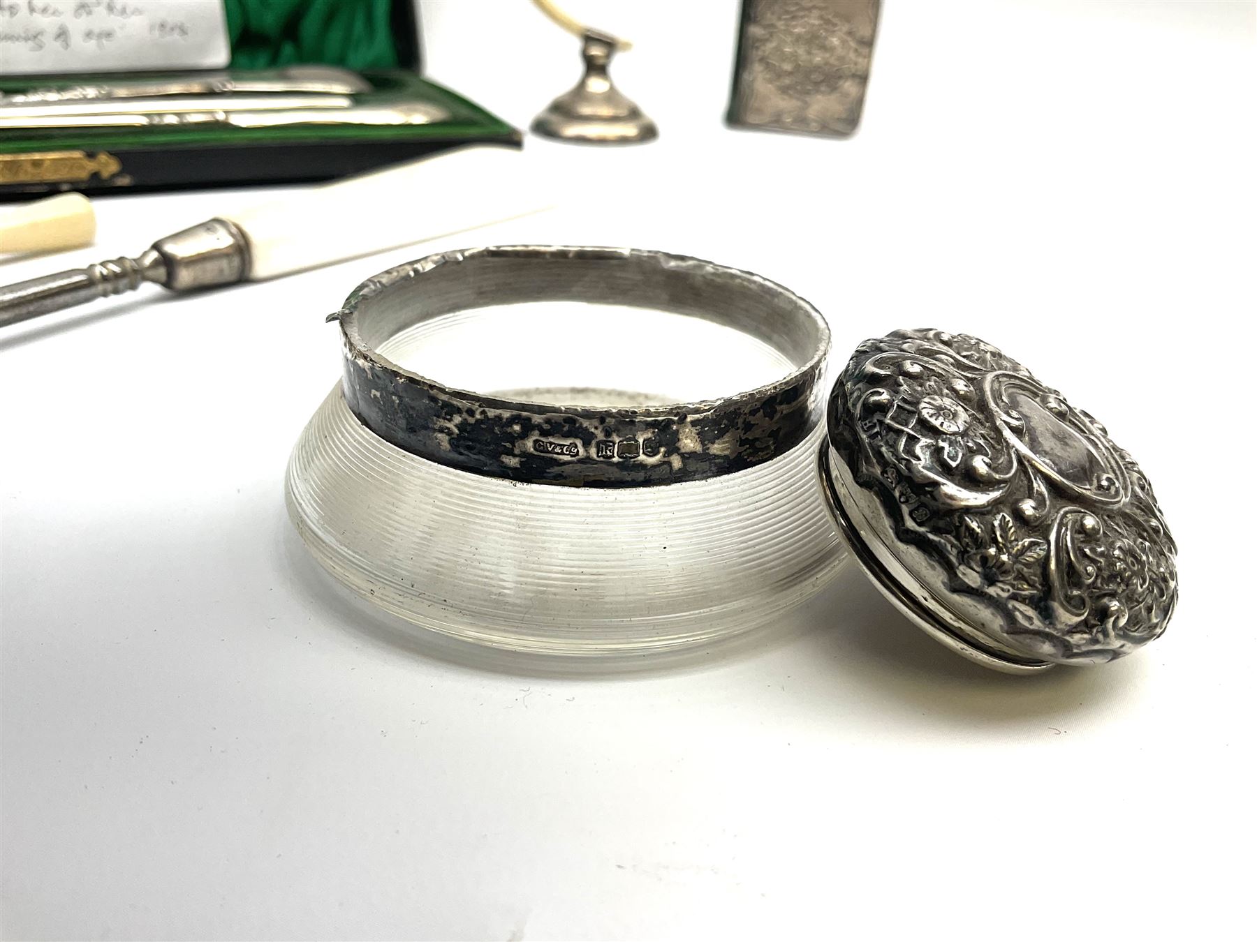 Cased silver handled glove stretcher, button hook, shoe horn, etc., hallmarked Adie & Lovekin Ltd, Chester 1911, and Adie & Lovekin Ltd, Birmingham 1911, miniature silver mounted hymn book, the cover embossed with cherubs, silver handled button hook, ivory handled button hook with silver ferrule, two silver dressing table pot lids, etc. 