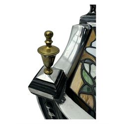 Stained glass and cast iron electric fireplace, arched top with decorative finials, stained glass front panel with floral motifs, flanked by cast iron scrolls, raised on scroll supports