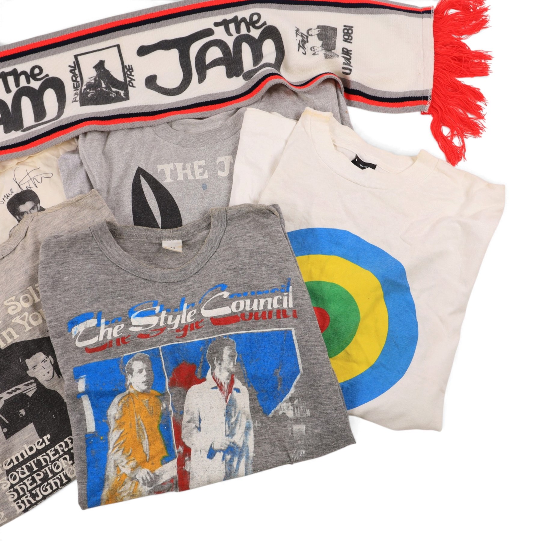 Five 1980s The Jam/Paul Weller/The Style Council tour/band t-shirts, including Cafe Bleu, The Paul Weller Movement, Dig The New Breed, A Solid Bond in Your Heart and Beat Surrender Tour 1982, together with a 1981 The Jam tour scarf and a Baby Axe Company miniature model of Paul Weller's Rickenbacker guitar